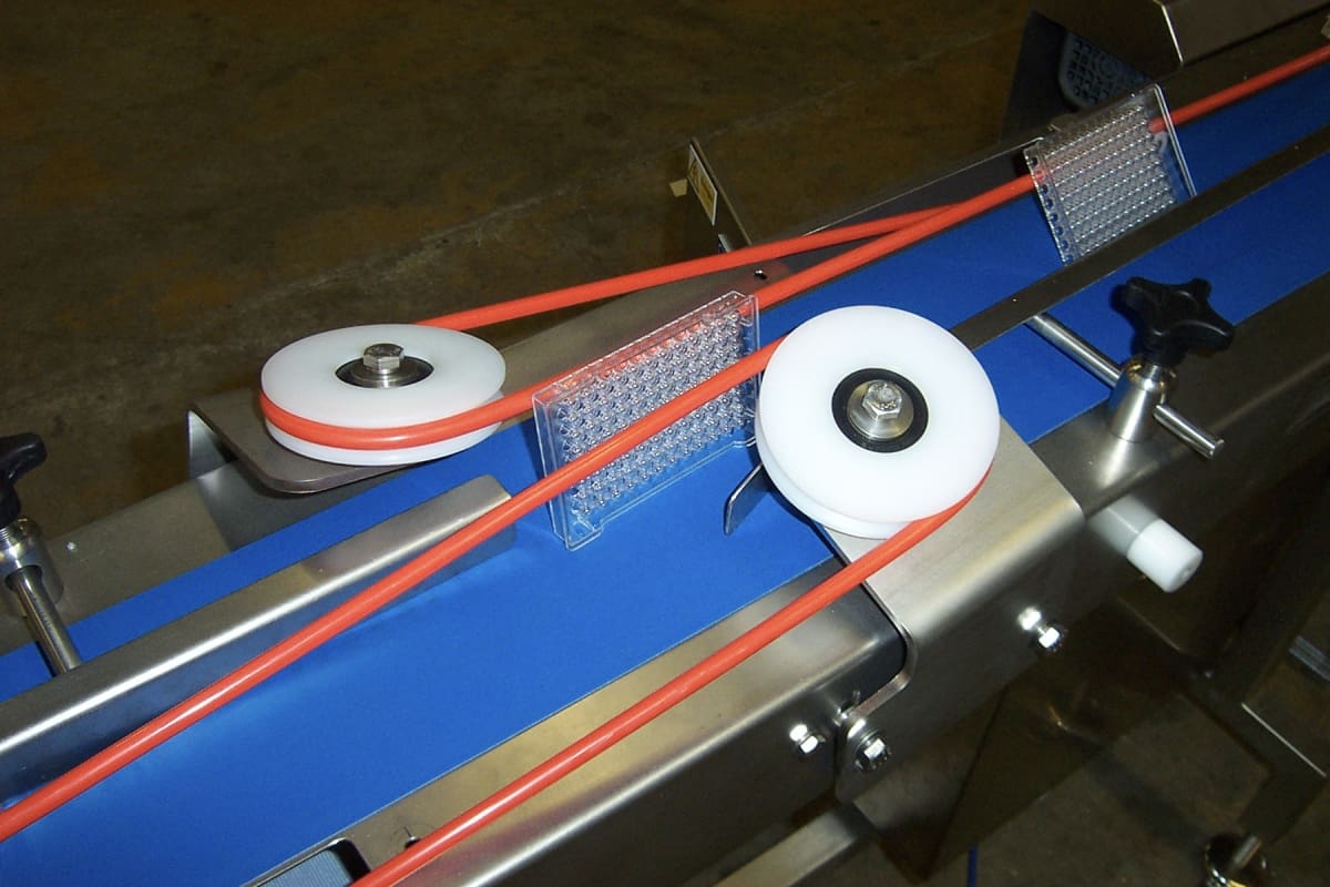 Medical Sample Tray Turning using Powered Guides